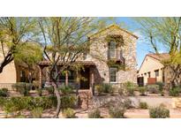 Charming two-story stone home with a cozy front porch and manicured landscaping at 9282 E Desert Vw, Scottsdale, AZ 85255