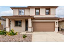 Charming two-story home with a two car garage, landscaped front yard, and neutral color palette at 16954 W Molly Ln, Surprise, AZ 85387