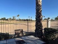 A relaxing patio with tile table and a lovely view of the open green space at 1759 N Sinova --, Mesa, AZ 85205