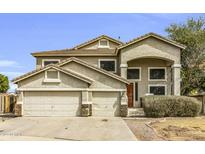 Inviting two-story home featuring a three-car garage and stucco siding at 2015 S 80Th Ln, Phoenix, AZ 85043