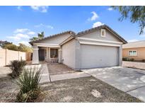 Charming single-story home with a well-maintained front yard and attached two-car garage at 34717 N Picket Post Dr, San Tan Valley, AZ 85144