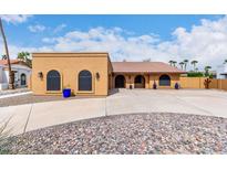 A single-story home with a desert landscape, covered entry, and a warm, inviting facade at 3826 E Equestrian Trl, Phoenix, AZ 85044