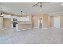 Modern kitchen with granite countertops, white cabinets, and stainless steel appliances at 4130 N Del Monte Dr, Eloy, AZ 85131