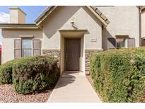 Charming home featuring a covered entry, a stone facade, and trimmed bushes along the walkway at 4675 E Olney Ave, Gilbert, AZ 85234