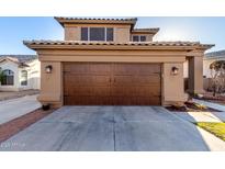 Charming home featuring an attached two car garage and concrete driveway at 7371 W Louise Dr, Glendale, AZ 85310