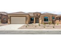Charming single-story home featuring a tile roof, two-car garage, and desert landscaping at 7854 W Mockingbird Way, Florence, AZ 85132