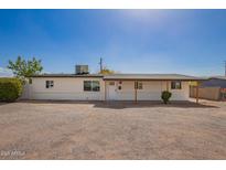 Charming single-story home with white exterior, desert landscaping, and covered entryway at 9127 E Broadway Rd, Mesa, AZ 85208