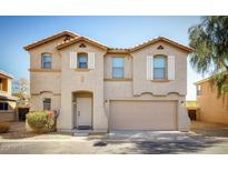 Charming two-story home with a two car garage and well manicured front yard and neutral colored exterior at 9643 N 81St Dr, Peoria, AZ 85345