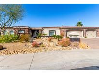 Charming home featuring a desert landscape with a two car garage and a red tile roof under a bright blue sky at 10534 N 133Rd St, Scottsdale, AZ 85259
