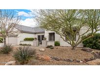 Charming home featuring mature landscaping with rock accents and covered front patio at 16210 W Desert Winds Dr, Surprise, AZ 85374