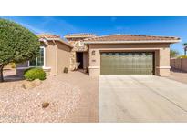 Charming single-story home featuring a well-manicured lawn and a two-car garage at 2403 N 163Rd Dr, Goodyear, AZ 85395