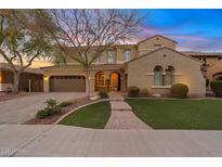 Charming two-story home featuring a landscaped front yard and a two-car garage with brick accents at 2670 E Parkview Dr, Gilbert, AZ 85295