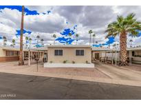 Charming single-story home with a carport and well-maintained landscaping including many palm trees at 2700 E Allred Ave # A3, Mesa, AZ 85204
