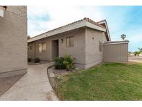 Charming single-story home with well-maintained landscaping and a quaint walkway leading to the entrance at 406 E Washington Ave # C, Gilbert, AZ 85234