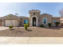 Charming home featuring a decorative front door and turret detail, complemented by low-maintenance desert landscaping at 4884 S Hemet St, Gilbert, AZ 85298
