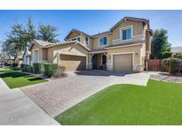 Beautiful two-story home featuring a three-car garage and a well-manicured front yard at 7363 E Plata Ave, Mesa, AZ 85212