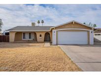 Charming single-story home with a two-car garage and desert landscaping at 7405 W Vogel Ave, Peoria, AZ 85345