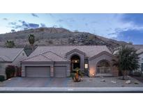 Charming home with a two-car garage, desert landscaping, and a mountain backdrop at 16060 S 4Th St, Phoenix, AZ 85048