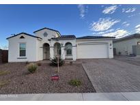 Charming single-story home with an attached two-car garage and beautifully landscaped front yard at 17019 W Cameron Dr, Surprise, AZ 85388