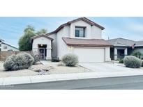 Charming two-story home with a well-maintained front yard and two car garage at 17059 W Northampton Rd, Surprise, AZ 85374