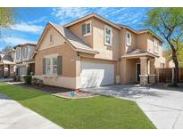 Two-story home showcasing desert landscaping, neutral stucco and a two car attached garage at 2331 E Pecan Rd, Phoenix, AZ 85040