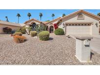 Charming home featuring desert landscaping, palm trees, and a two-car garage at 3032 N 160Th Ave, Goodyear, AZ 85395