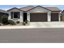 Charming single-story home with a two car garage, desert landscaping, and a neutral color palette at 40440 W Haley Dr, Maricopa, AZ 85138
