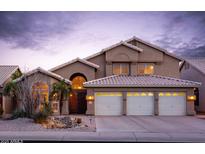 Charming two-story home featuring a three-car garage, desert landscaping, and well-lit exterior at 5381 W Del Rio St, Chandler, AZ 85226