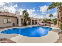 Backyard featuring a private pool, covered patio, and lush landscaping at 6118 E Star Valley St, Mesa, AZ 85215