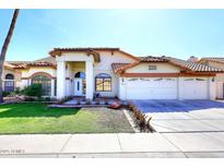 Inviting single-Gathering home with a well-manicured lawn and a three car garage at 819 W Harbor Dr, Gilbert, AZ 85233