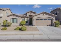Charming single-story home with desert landscaping and a two-car garage at 16830 W Magnolia St, Goodyear, AZ 85338