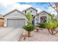 Charming single-Gathering home featuring desert landscaping and a two-car garage at 212 E Canary Ct, San Tan Valley, AZ 85143