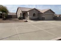 Charming single-story home with a well-manicured yard and a spacious driveway at 24638 N 65Th Ave, Glendale, AZ 85310