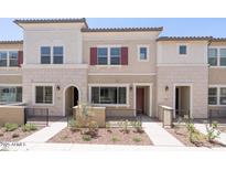 Inviting townhome featuring desert landscaping, neutral tones and symmetrical design at 2663 S Equestrian Dr # 106, Gilbert, AZ 85295