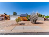 Charming single-story home featuring desert landscaping, solar panels, and a two-car garage at 340 E Harwell Rd, Gilbert, AZ 85234