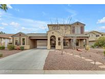 Two-story home showcasing a well-manicured front yard with desert landscaping and an extended driveway at 3777 E Latham Ct, Gilbert, AZ 85297