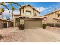 Traditional two-story home with a two car garage, desert landscaping, and an American flag at 4148 E Coolbrook Ave, Phoenix, AZ 85032