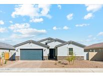 Charming single-story home featuring a well-manicured front yard and a two-car garage at 5046 W Karl St, San Tan Valley, AZ 85144