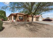Charming single-story home with desert landscaping, a two-car garage, and a detached garage at 5622 E Emerald Cir, Mesa, AZ 85206