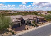 Spacious home with a three-car garage and desert landscaping, nestled in a community with mountain views at 5723 E Jake Hvn, Cave Creek, AZ 85331