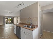 Bright kitchen featuring stainless steel appliances, double basin sink, and tile backsplash at 7430 E Chaparral Rd # A239, Scottsdale, AZ 85250