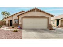 Charming home featuring a two-car garage with a neutral-toned door and meticulously maintained landscaping at 8541 W Echo Ln, Peoria, AZ 85345
