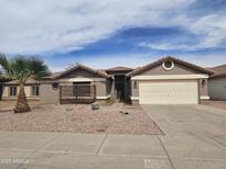 Charming single-story home featuring a two-car garage, desert landscaping, and a welcoming entrance at 1244 E Princeton Ave, Gilbert, AZ 85234