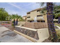 Inviting condo exterior with well-manicured landscaping and a decorative water fountain feature at 1331 W Baseline Rd # 340, Mesa, AZ 85202