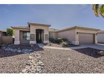 Charming single-story home with desert landscaping and neutral color palette at 14837 W Crocus Dr, Surprise, AZ 85379