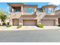 Charming townhome featuring a neutral color scheme, multiple garage spaces, and a private balcony at 16420 N Thompson Peak Pkwy # 1064, Scottsdale, AZ 85260