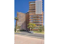 Multi-story building exterior featuring balconies, landscaping, and a circular driveway at 2201 N Central Ave # 11A, Phoenix, AZ 85004