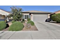 Charming single-story home with a well-maintained front yard and a two-car garage at 27138 W Escuda Dr, Buckeye, AZ 85396