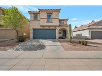 Charming two-story home featuring desert landscaping, a two car garage, and neutral earth-tone colors at 3049 E Santa Rosa Dr, Gilbert, AZ 85234