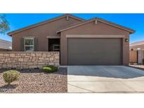 Charming single-story home featuring a two-car garage, stone accents, and low-maintenance landscaping at 3903 E French Trotter St, San Tan Valley, AZ 85140